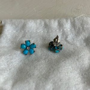 Silver and turquoise five petal flower stud earrings with sparkly center stone.